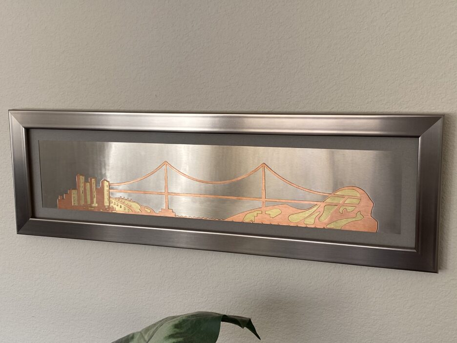 A fire place with a picture of the golden gate bridge.