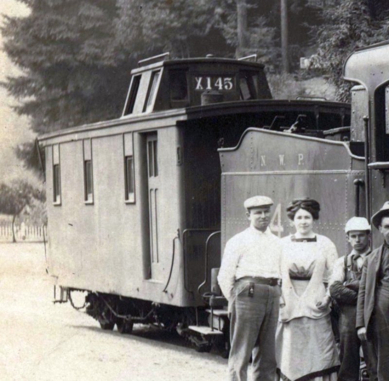 A group of people standing next to a train.