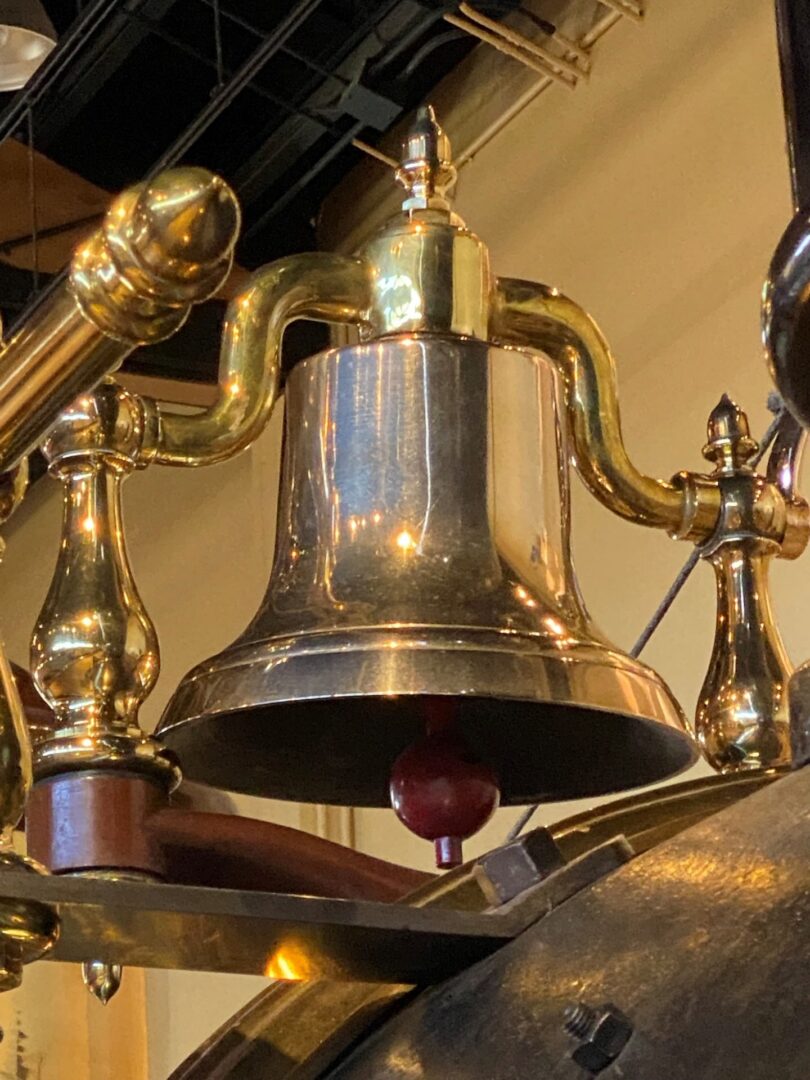 A bell hanging from the ceiling of a room.