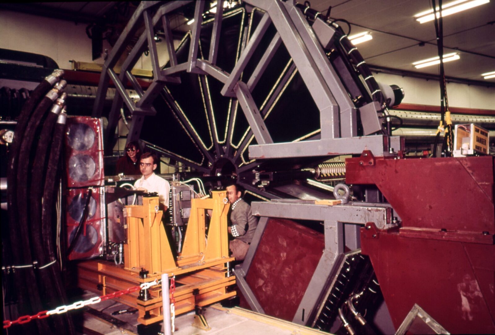 A man standing next to a large machine.